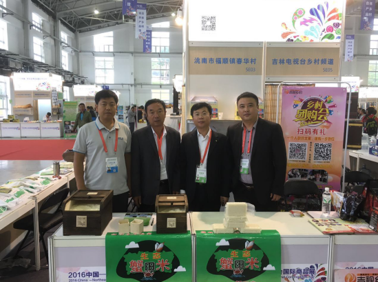 　　董为春(左二)一行四人参展推销蟹田稻